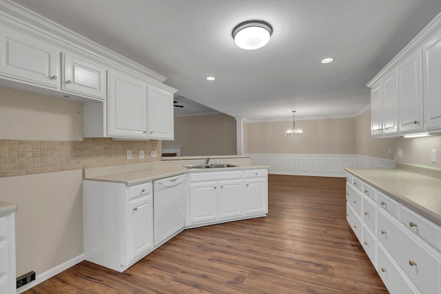 3319 Mershon Dr, Murfreesboro, TN 37128 - kitchen featuring white dishwasher, a peninsula, ornamental molding, a chandelier, and white cabinetry