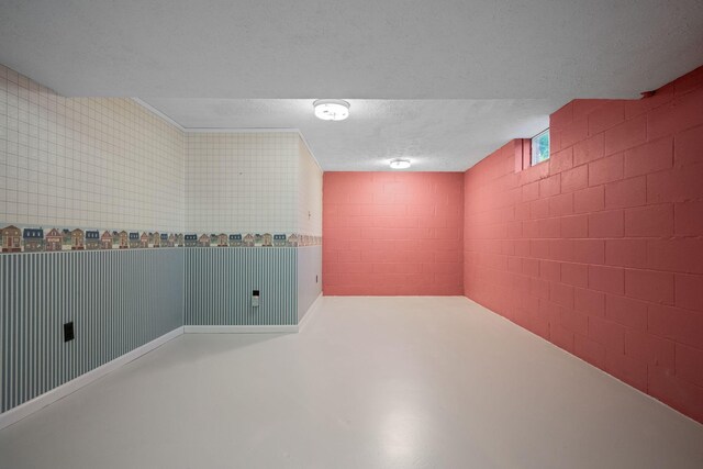 915 Taylor Cir, Burns, TN 37029 - basement featuring concrete block wall and a textured ceiling