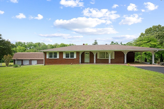 915 Taylor Cir, Burns, TN 37029 - ranch-style house with asphalt driveway, a front lawn, brick siding, and covered porch
