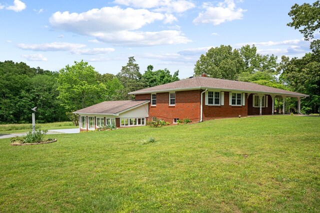 915 Taylor Cir, Burns, TN 37029 - view of property exterior featuring brick siding, a yard, and driveway