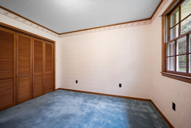 915 Taylor Cir, Burns, TN 37029 - unfurnished bedroom featuring carpet floors, crown molding, baseboards, a closet, and a textured ceiling