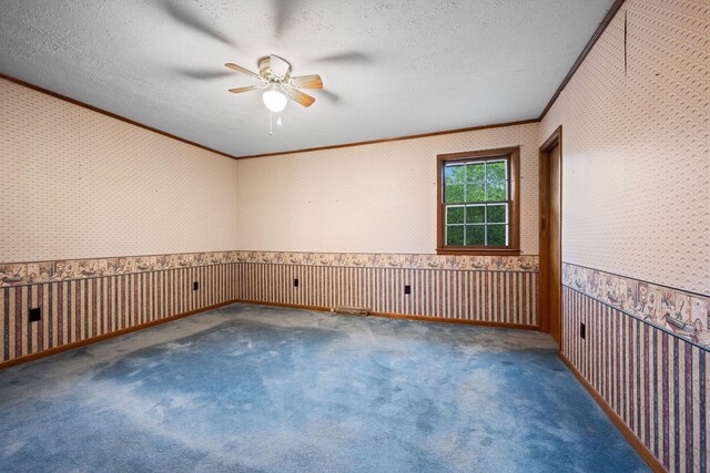 915 Taylor Cir, Burns, TN 37029 - empty room featuring wallpapered walls, a ceiling fan, crown molding, a wainscoted wall, and carpet
