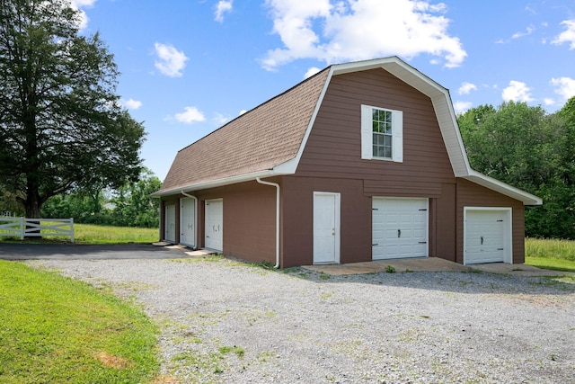 915 Taylor Cir, Burns, TN 37029 - view of side of property featuring a shingled roof, a gambrel roof, an outdoor structure, a barn, and a detached garage