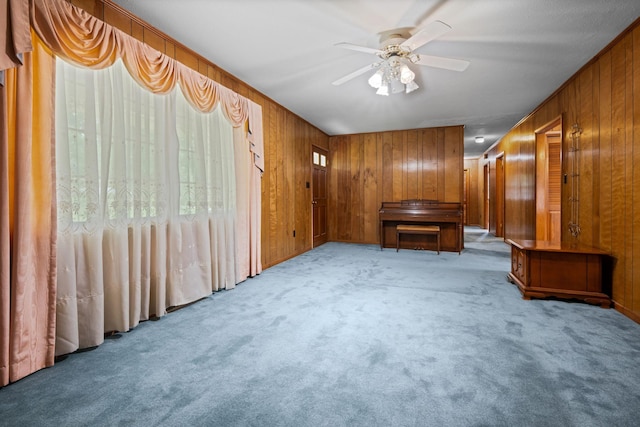 915 Taylor Cir, Burns, TN 37029 - unfurnished room with wood walls, carpet, and a ceiling fan