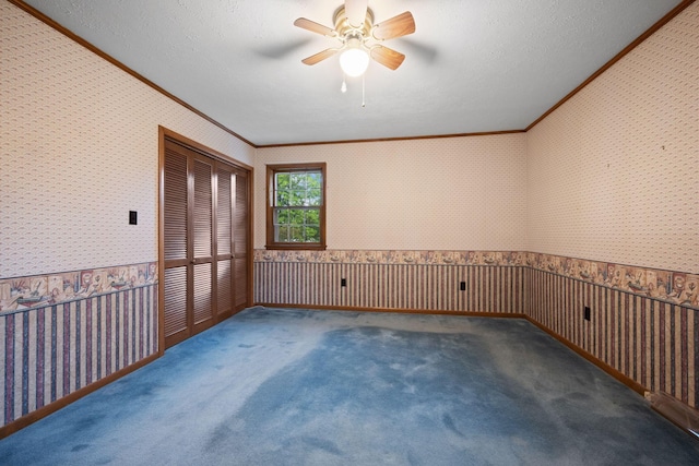 915 Taylor Cir, Burns, TN 37029 - carpeted empty room with wallpapered walls, crown molding, wainscoting, and a ceiling fan