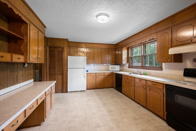 915 Taylor Cir, Burns, TN 37029 - kitchen featuring white appliances, under cabinet range hood, brown cabinets, light countertops, and a textured ceiling