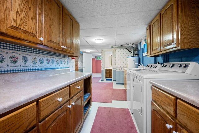 915 Taylor Cir, Burns, TN 37029 - laundry area featuring washer and clothes dryer, water heater, cabinet space, and light floors