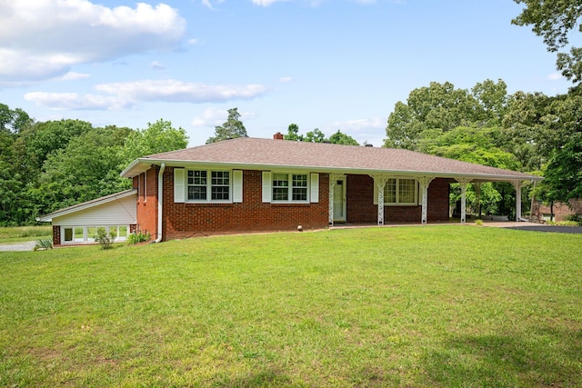 915 Taylor Cir, Burns, TN 37029 - single story home with a front lawn, brick siding, a chimney, and a carport