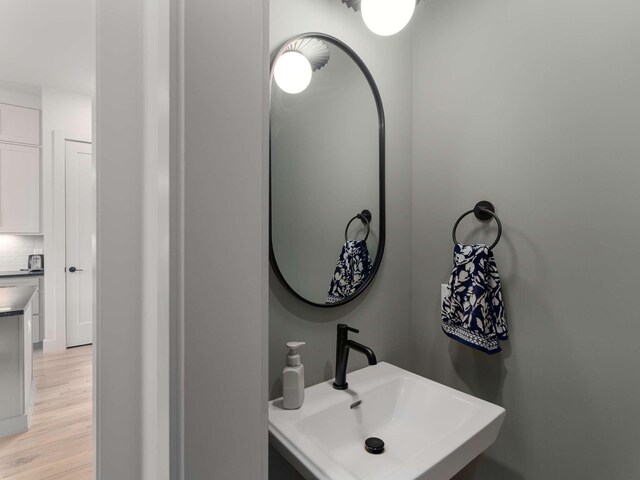 1319 Monetta Ave, Nashville, TN 37216 - bathroom featuring a sink, wood finished floors, and decorative backsplash