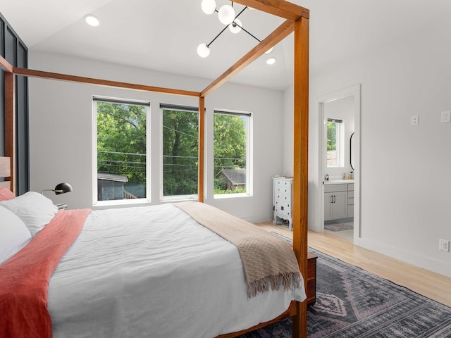 1319 Monetta Ave, Nashville, TN 37216 - bedroom featuring wood finished floors, baseboards, ensuite bathroom, and a chandelier