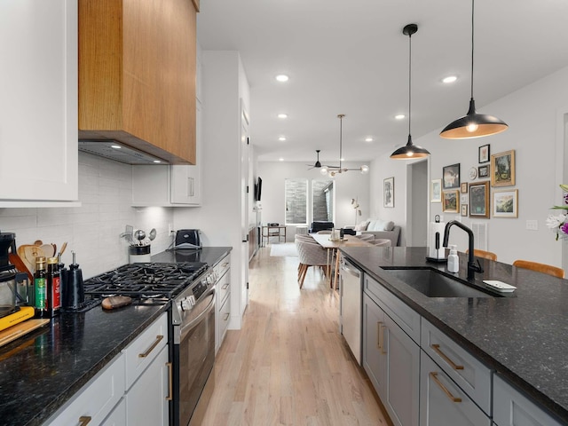 1319 Monetta Ave, Nashville, TN 37216 - kitchen with appliances with stainless steel finishes, a sink, light wood finished floors, backsplash, and open floor plan