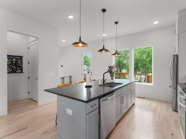 1319 Monetta Ave, Nashville, TN 37216 - kitchen featuring a sink, appliances with stainless steel finishes, light wood-style flooring, gray cabinetry, and dark countertops