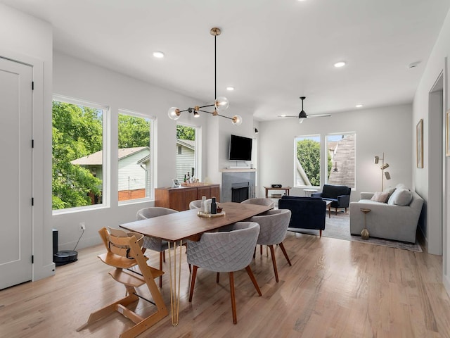 1319 Monetta Ave, Nashville, TN 37216 - dining area featuring a tile fireplace, light wood-type flooring, a ceiling fan, recessed lighting, and a chandelier