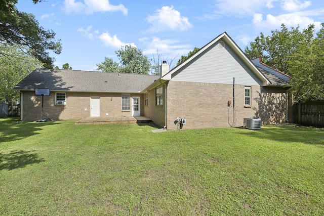 rear view of property with central AC, a chimney, brick siding, and a patio