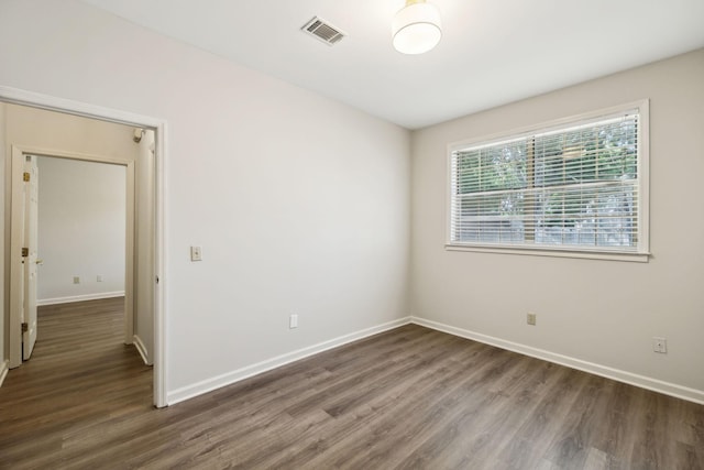 empty room with wood finished floors and baseboards