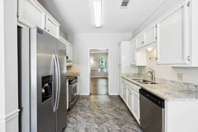 kitchen with stainless steel appliances, a sink, white cabinetry, and ornamental molding