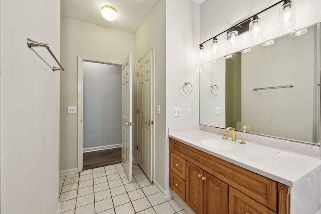bathroom featuring tile patterned flooring, vanity, and baseboards