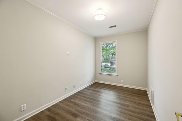 unfurnished room featuring crown molding, baseboards, and dark wood finished floors