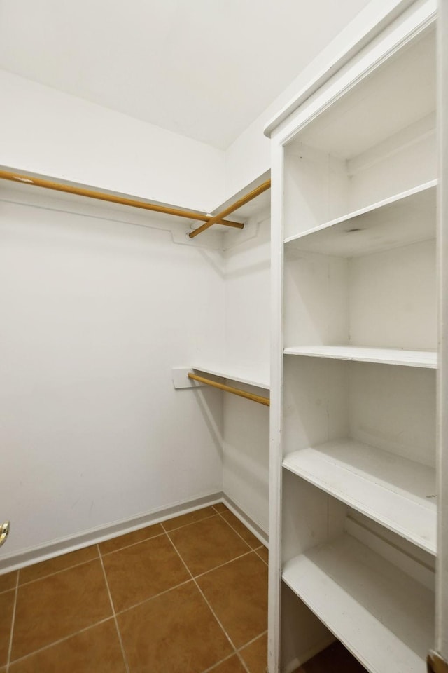 walk in closet featuring tile patterned flooring