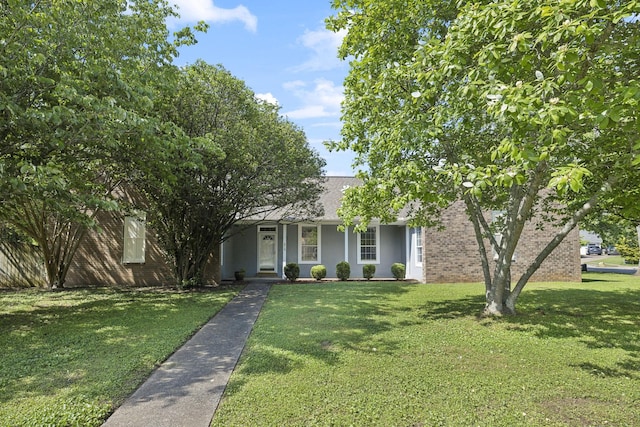obstructed view of property featuring a front yard, brick siding, and a shingled roof