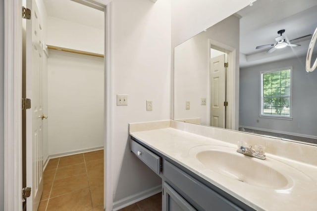 bathroom featuring vanity, ceiling fan, tile patterned flooring, and baseboards