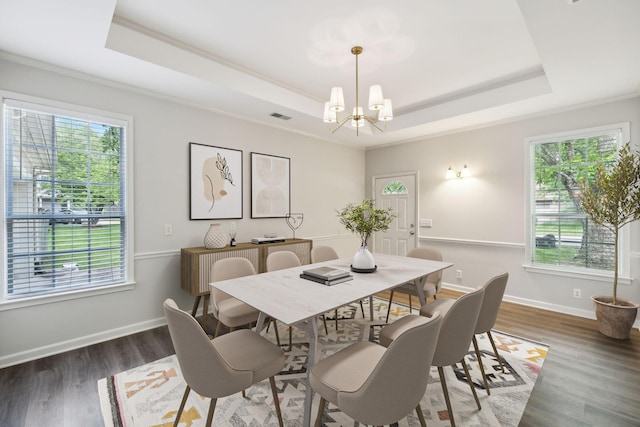 dining space featuring a tray ceiling, a chandelier, healthy amount of natural light, and ornamental molding