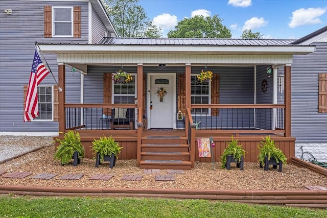 view of front of home with a porch and metal roof