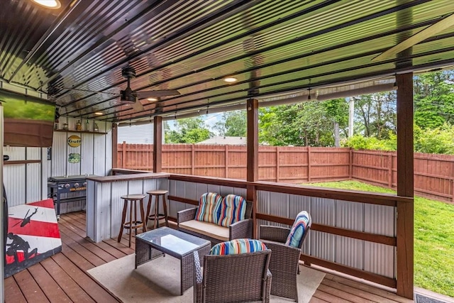 sunroom / solarium with a ceiling fan