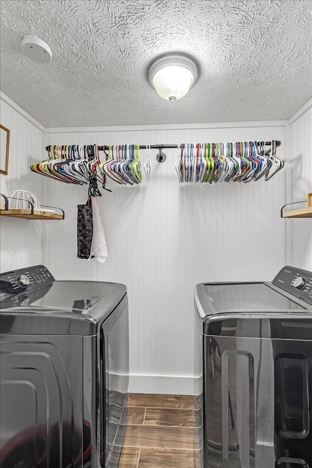 laundry area featuring washer and dryer, dark wood-style floors, baseboards, and a textured ceiling