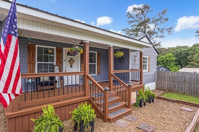 wooden deck with fence and a porch