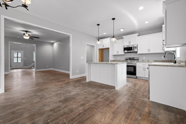 1860 Oakvale Dr, Chattanooga, TN 37421 - kitchen with appliances with stainless steel finishes, baseboards, dark wood-style flooring, white cabinetry, and pendant lighting