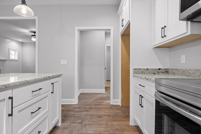 1860 Oakvale Dr, Chattanooga, TN 37421 - kitchen featuring appliances with stainless steel finishes, a ceiling fan, light wood-style flooring, white cabinetry, and light stone countertops