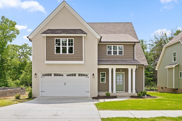 1860 Oakvale Dr, Chattanooga, TN 37421 - view of front of property featuring driveway, covered porch, an attached garage, a front lawn, and roof with shingles