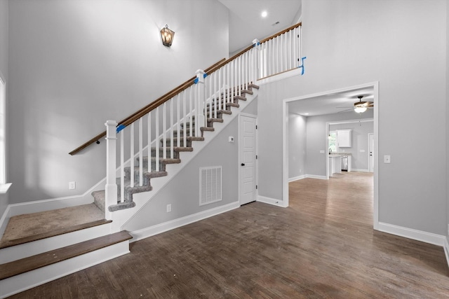 1860 Oakvale Dr, Chattanooga, TN 37421 - staircase with wood finished floors, baseboards, a ceiling fan, and a towering ceiling