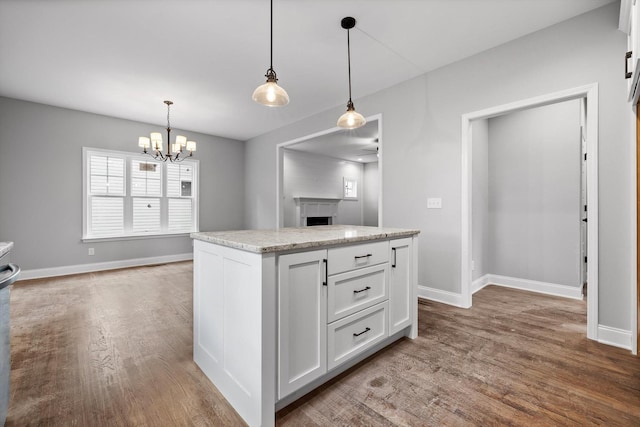 1860 Oakvale Dr, Chattanooga, TN 37421 - kitchen featuring wood finished floors, a chandelier, white cabinets, and baseboards