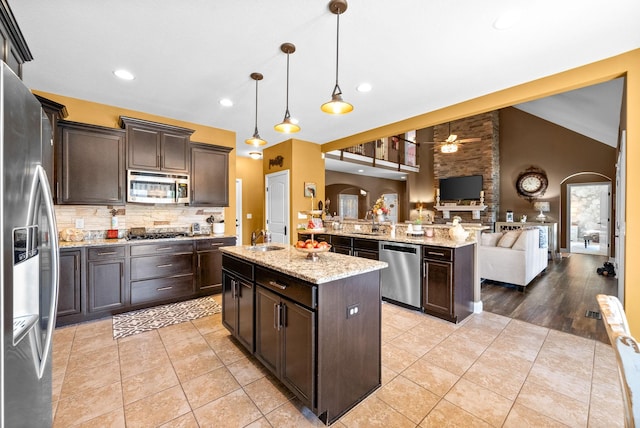 3015 Prince Dr, Clarksville, TN 37043 - kitchen featuring stainless steel appliances, ceiling fan, open floor plan, a sink, and dark brown cabinets