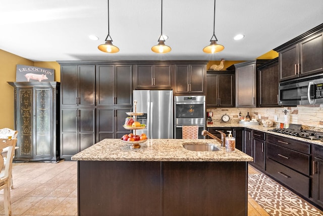 3015 Prince Dr, Clarksville, TN 37043 - kitchen featuring appliances with stainless steel finishes, a sink, decorative backsplash, dark brown cabinets, and hanging light fixtures