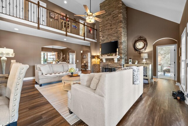 3015 Prince Dr, Clarksville, TN 37043 - living area featuring high vaulted ceiling, arched walkways, wood finished floors, a ceiling fan, and a fireplace
