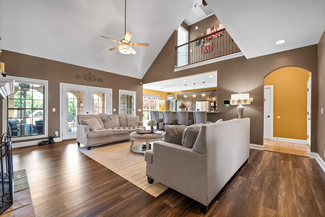 3015 Prince Dr, Clarksville, TN 37043 - living room featuring arched walkways, a ceiling fan, wood finished floors, healthy amount of natural light, and high vaulted ceiling