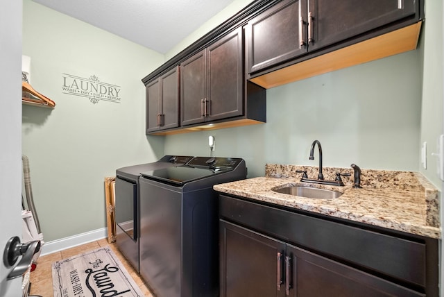 3015 Prince Dr, Clarksville, TN 37043 - laundry room featuring washing machine and dryer, cabinet space, light tile patterned floors, and baseboards