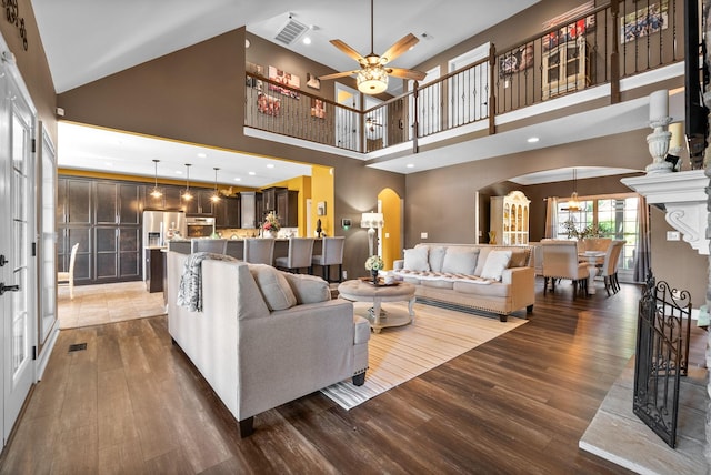 3015 Prince Dr, Clarksville, TN 37043 - living area featuring arched walkways, wood finished floors, a ceiling fan, and a towering ceiling