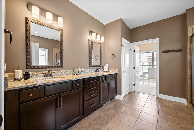 3015 Prince Dr, Clarksville, TN 37043 - full bath with double vanity, baseboards, tiled shower, and tile patterned flooring