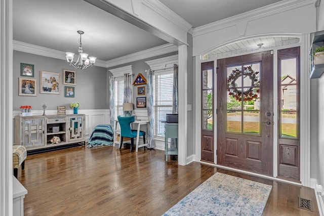 1002 Loblolly Dr, Murfreesboro, TN 37128 - entrance foyer with a chandelier, wood finished floors, crown molding, and a wainscoted wall