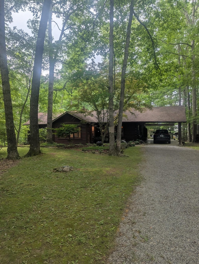 view of front of house with a carport and asphalt driveway