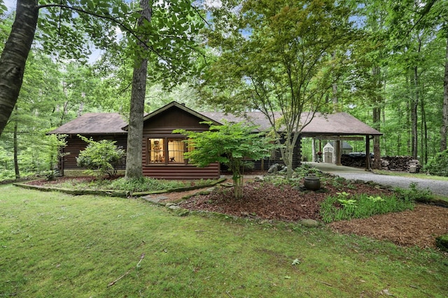 7261 Kingston Rd, Fairview, TN 37062 - view of front of house featuring a front lawn, driveway, a carport, and log exterior