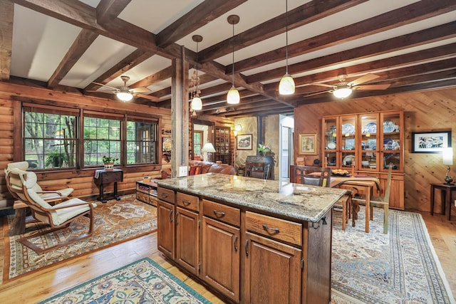 7261 Kingston Rd, Fairview, TN 37062 - kitchen with a ceiling fan, light wood-type flooring, open floor plan, wood walls, and beamed ceiling