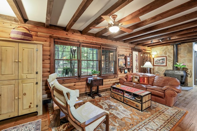 7261 Kingston Rd, Fairview, TN 37062 - living area with a wood stove, beamed ceiling, light wood-style flooring, and ceiling fan