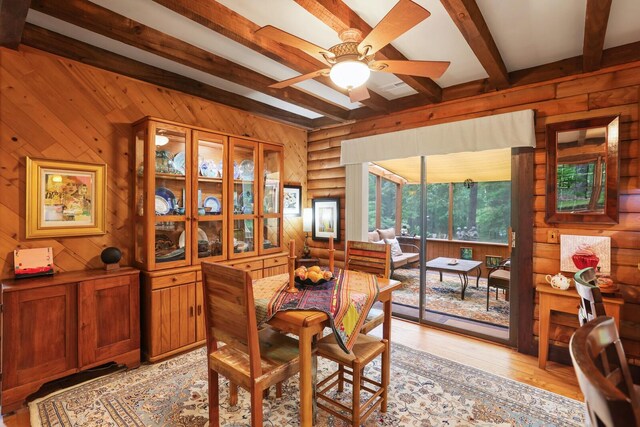 7261 Kingston Rd, Fairview, TN 37062 - dining room featuring a ceiling fan, beamed ceiling, wood walls, light wood-style floors, and a sunroom