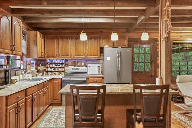 7261 Kingston Rd, Fairview, TN 37062 - kitchen with appliances with stainless steel finishes, a sink, beamed ceiling, light countertops, and brown cabinetry
