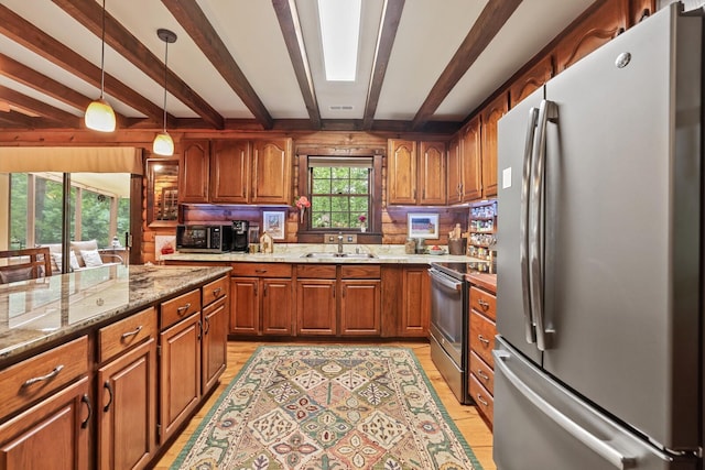 7261 Kingston Rd, Fairview, TN 37062 - kitchen with appliances with stainless steel finishes, beamed ceiling, a sink, brown cabinets, and light wood finished floors